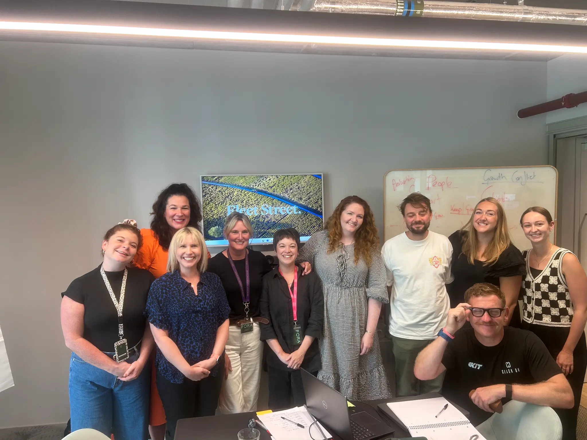 A group takes part in a facilitated Crack On session in a Fleet Street PR-branded environment